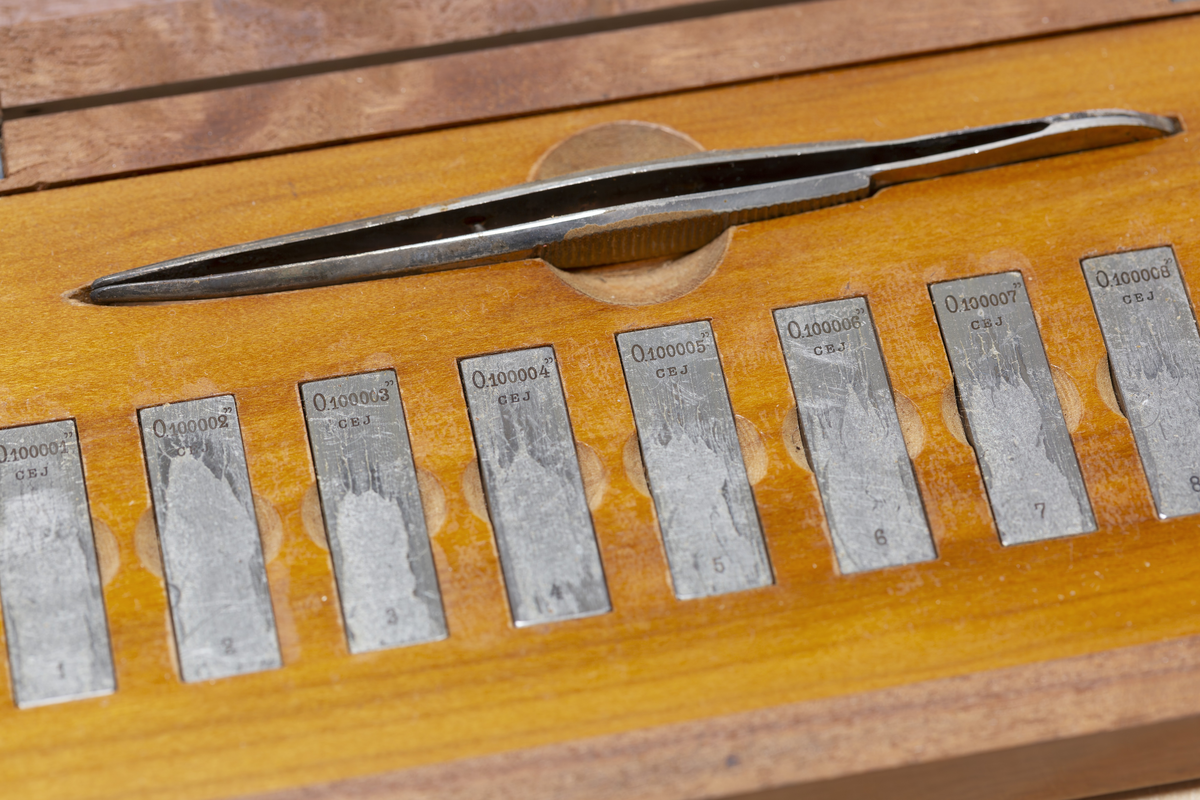 C. E. Johansson wanted to develop a set of combination gauge blocks that could be combined with each other to be able to provide all the measurements needed in industrial manufacturing. His combination gauge first had 102, then 46 pieces of steel that became world famous. The steel pieces' surfaces were so even that they were held together and could not be pulled apart. Instead, they would be pushed apart laterally. The pieces of steel could form a rod of precise length that could be picked up and held without falling apart. It was used to calibrate other measuring tools and machines. He went down in history as Mått-Johansson and worked for a time for Henry Ford in the USA.