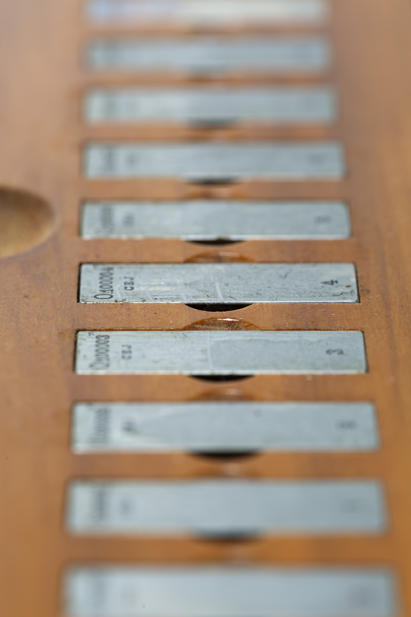 C. E. Johansson wanted to develop a set of combination gauge blocks that could be combined with each other to be able to provide all the measurements needed in industrial manufacturing. His combination gauge first had 102, then 46 pieces of steel that became world famous. The steel pieces' surfaces were so even that they were held together and could not be pulled apart. Instead, they would be pushed apart laterally. The pieces of steel could form a rod of precise length that could be picked up and held without falling apart. It was used to calibrate other measuring tools and machines. He went down in history as Mått-Johansson and worked for a time for Henry Ford in the USA.