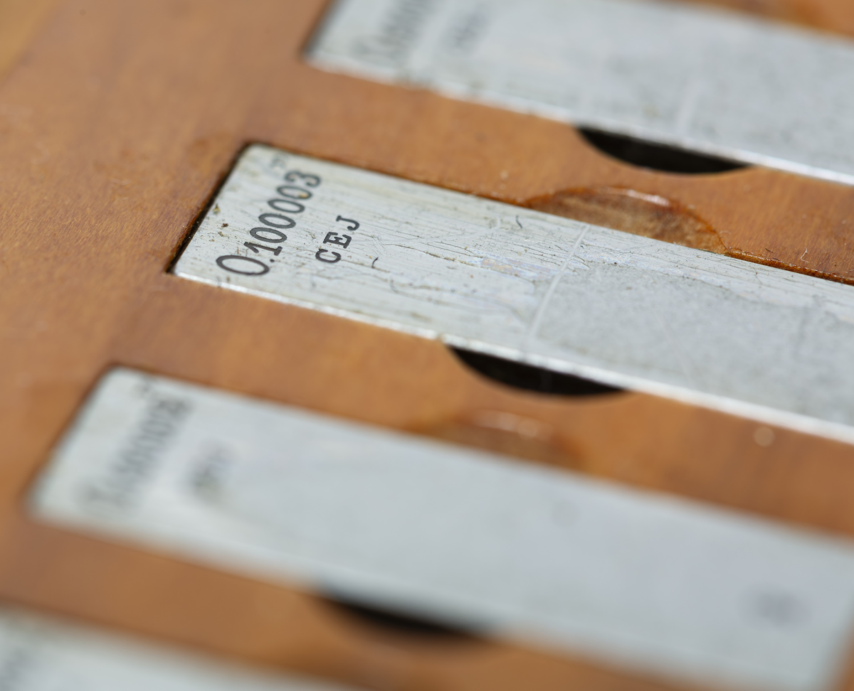 C. E. Johansson wanted to develop a set of combination gauge blocks that could be combined with each other to be able to provide all the measurements needed in industrial manufacturing. His combination gauge first had 102, then 46 pieces of steel that became world famous. The steel pieces' surfaces were so even that they were held together and could not be pulled apart. Instead, they would be pushed apart laterally. The pieces of steel could form a rod of precise length that could be picked up and held without falling apart. It was used to calibrate other measuring tools and machines. He went down in history as Mått-Johansson and worked for a time for Henry Ford in the USA.