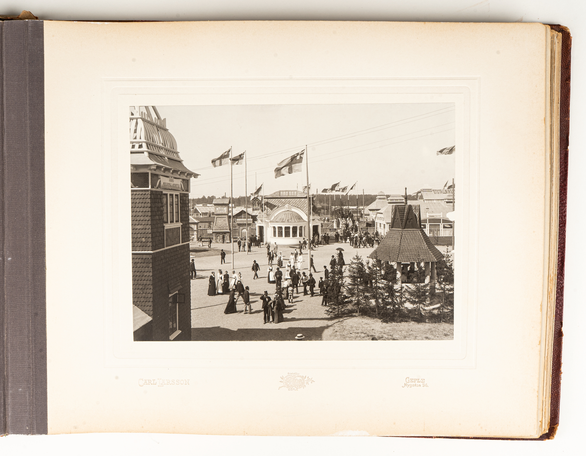 Fotoalbum från Gävleutställningen 1901. Album med röda pärmar och text i guld.