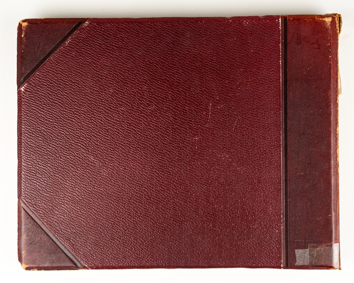 Fotoalbum från Gävleutställningen 1901. Album med röda pärmar och text i guld.