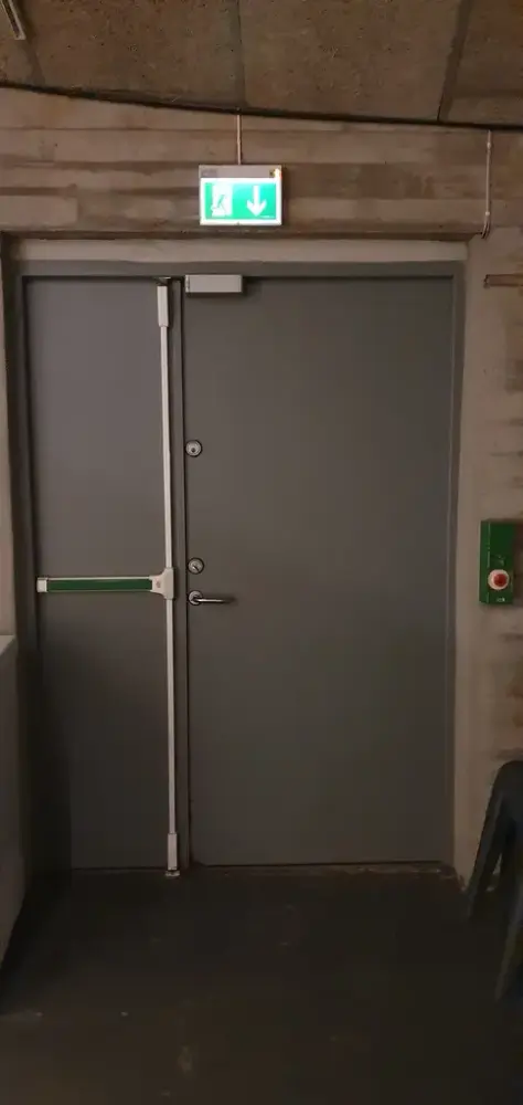 Grå dobbeldør i metall som er naudutgangsdør frå utstillingsrommet