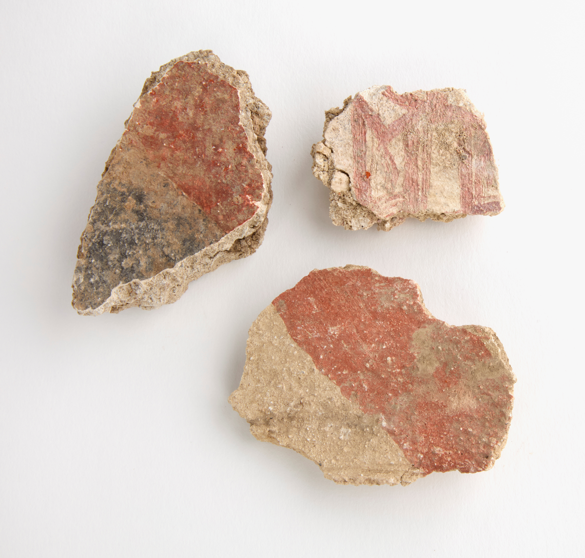 En samling av fragment av målad puts och bruk med kalkputs och bemålning. 17 fyndaskar med fragment i olika storlekar.

Fyndask 1: Totalt 13 fragment med röd och vit färg, en ser ut att ha träavtryck (varit fäst mot ett trästycke).

Fyndask 2: Totalt 7 fragment alla utom en har röd och vit färg, endast en med gråaktig obehandlad puts. 

Fyndask 3: Totalt 1 större fragment med röd och vit färg på enda sidan.

Fyndask 4: Totalt 4 fragment alla utom en med röd och vit färg, endast en med vit puts. 

Fyndask 5: Totalt 3 fragment med röd och vit färg, varav en är sotig. 

Fyndask 6: Totalt 3 fragment med röd och vit färg, en mycket tydlig medan de andra två mer diffusa. 

Fyndask 7:  Totalt 27 fragment, 24 av dessa är bemålade med röd och vit färg, 3  fragment med gråaktig obehandlad puts. 

Fyndask 8: Totalt 5 fragment, varav 4 större och en mycket liten. Alla större fragment med olika karaktär. En med vit kalkbruk och utan putsad yta, en annan med svart och röd putsad yta. Det tredje fragmentet har lite rödfärgad puts bevarad och på andra sidan ser det ut att ha träavtryck (varit fäst mot ett trästycke). Det fjärde fragmentet har en mer brungrå nyans. I fyndasken låg en lapp med text N. om V. portalen. 

Fyndask 9: Totalt 13 fragment, varav ett större fragment med svart och rödmålad puts. Ett annat fragment med svart och vitmålad puts, det tredje fragmentet har endast svartmålad puts. Sedan finns tre rödmålande putsfragment, samt tre fragment med röda linjer. Fyra fragment är ytterst små och intetsägande.

Fyndask 10: Totalt 9 fragment samt smådelar varav två har rött färgfragment. Det största fragmentet samt fyra andra är svart- och rödmålat. Tre putsfragment har röda linjer.
 
Fyndask 11: Totalt 1 fragment med röda linjer samt en mindre del med blågråa linjer. 

Fyndask 12: Totalt 1 fragment med blågrå rundad linje samt samt en mindre punkt eller koncentration nedanför.  

Fyndask 13: Totalt 5 fragment varav två med rödmålad puts. De andra tre har linjer. 

Fyndask 14: Totalt 1 fragment med vit och rödmålad puts, med flertal linjer som eventuellt kan vara del av en bokstav.
 
Fyndask 15: Totalt 1 fragment med vit och svartmålad puts, med flertal linjer som eventuellt kan vara del av en större figur. Ena delen syns en större koncentration som skulle kunna vara en fågel. 

Fyndask 16: Totalt 1 fragment med vit och rödmålad puts, med flertal rundade linjer som eventuellt kan vara del av växtlig dekor.

Fyndask 17: Totalt 1 fragment med rödmålad puts, med en vit linje.