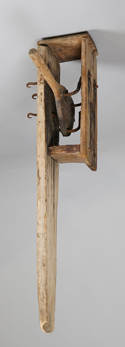 Reipslagarutstyr. Ei trefjøl med "kasse" i tre på eine sida (pluggar av tre). Inni kassa er det tre bøygde jarnstenger som er trædd gjennom tre hol i ei trefjøl. Denne trefjøla stikk ut frå "kassa"med eit handtak. Jarnstengane stikk ut gjennom tre hol på kvar side, eine sida som rette tappar, på andre sida (den lange fjøla), som krokar.