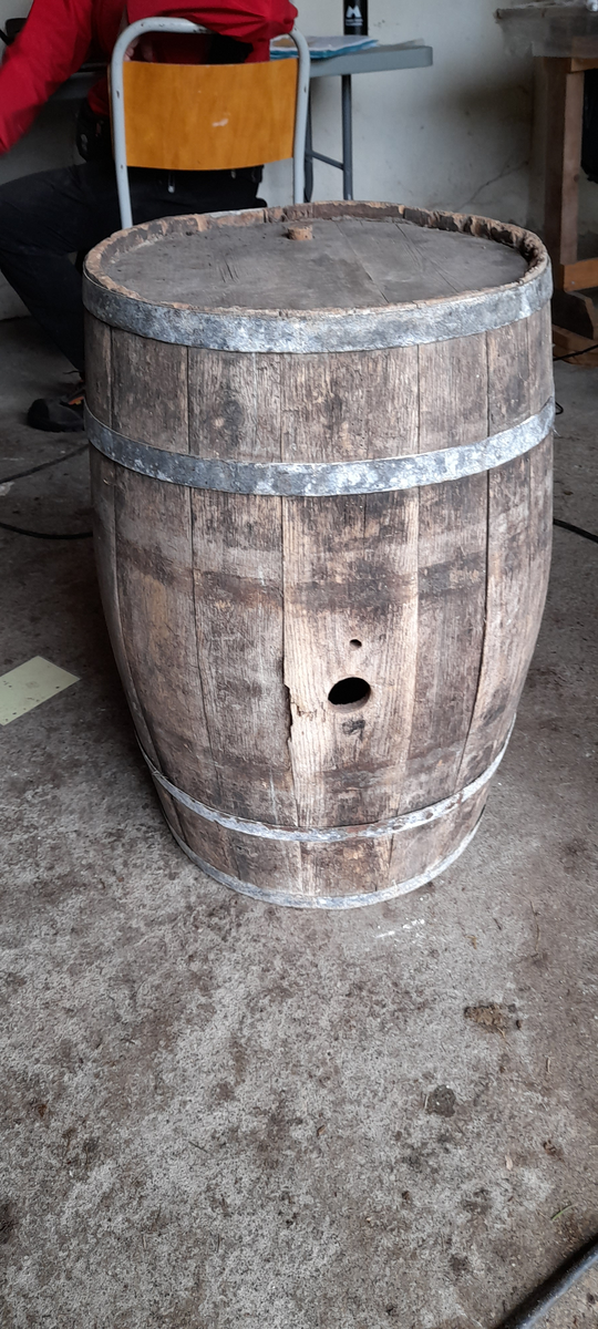 Tønne. Innsett botn og topp. Hol med treplugg i topp. Hol i sida. Fire metall band.