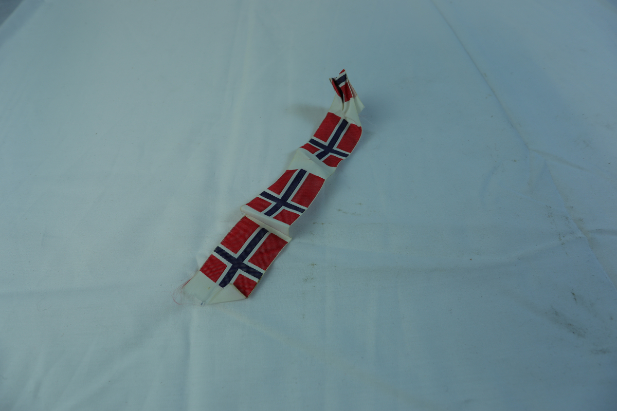 Remse i tekstil med fire norske flagg.