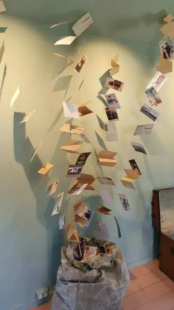 Installasjon med mange amerikabrev som flyger opp av en stor postsekk, 