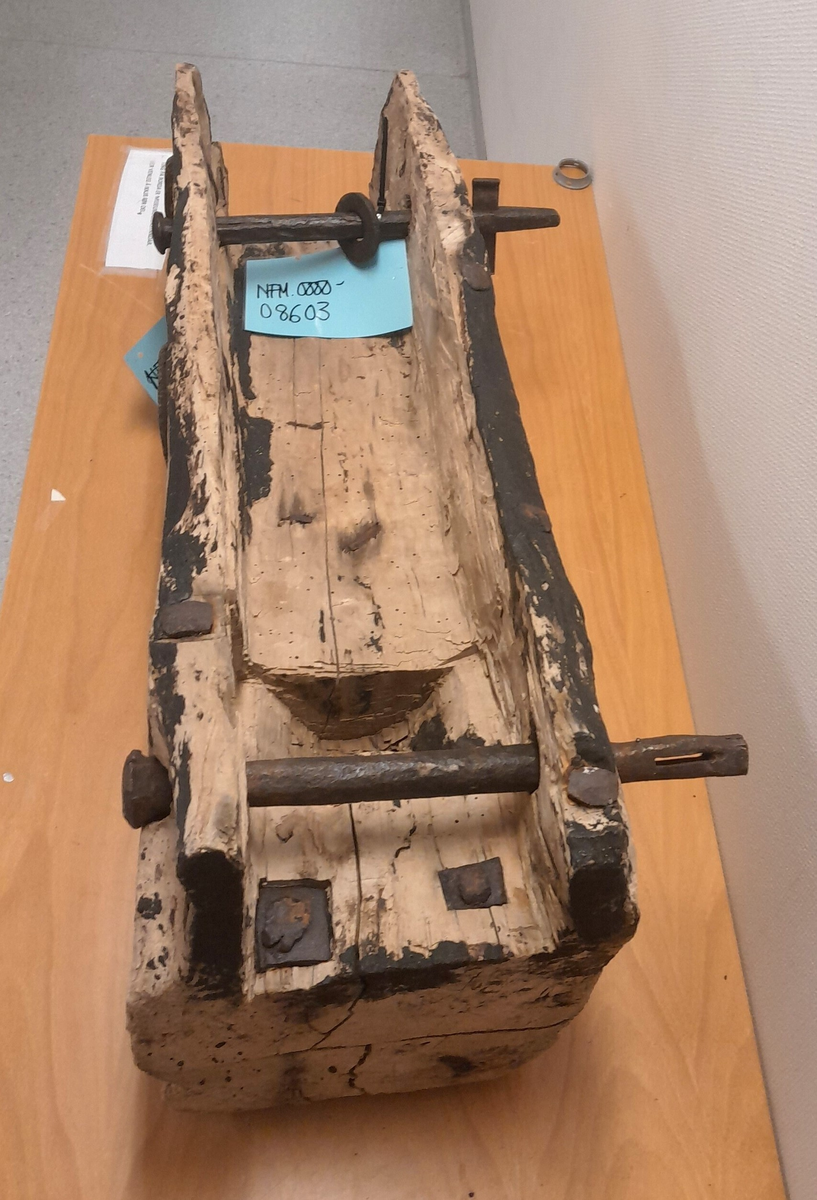 Renne i tre. Utholing truleg øksa ut.  Bolt i jarn gjennom to parallelle hol i sidene, oppe og nede. Boltane kan løysast og låsast. Jarn klammer og bolter (firekanta og runde hovud) er slått inn fleire stader i treet. Rektangulært hol i treet opp mot eine bolten. Områder med svart, truleg tjære.

Kan ha vore brukt på Holvikejekta som vern på baugen.