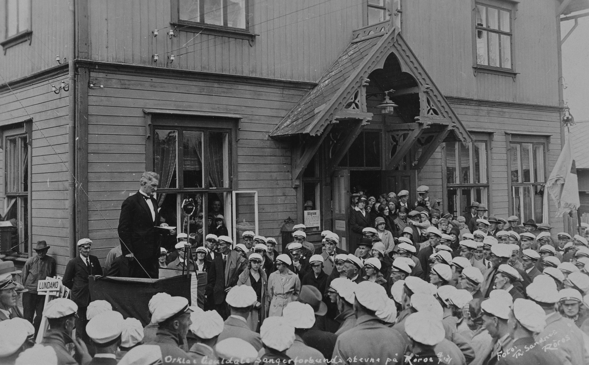 Johan Falkberget holder hilsningstale til en folkemengde ved Røros jernbanestasjon i forbindelse med Orkla og Gauldals Sangerforbunds stevne på Røros