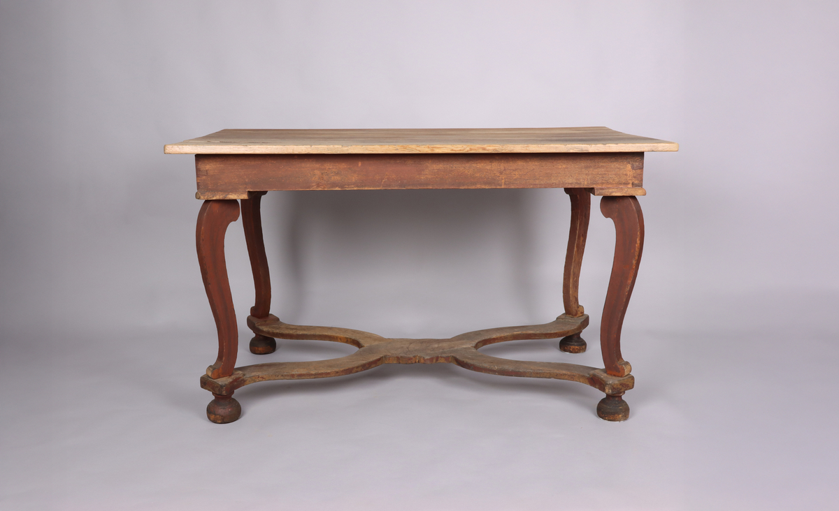 Bord av trä. Trären bordsskiva. 4 svängda ben. Varje ben avslutas med ett halvt svarvat klot. Svängd krysslå sammanför benen i nederkant. Rester av rödbrun färg på underredet.