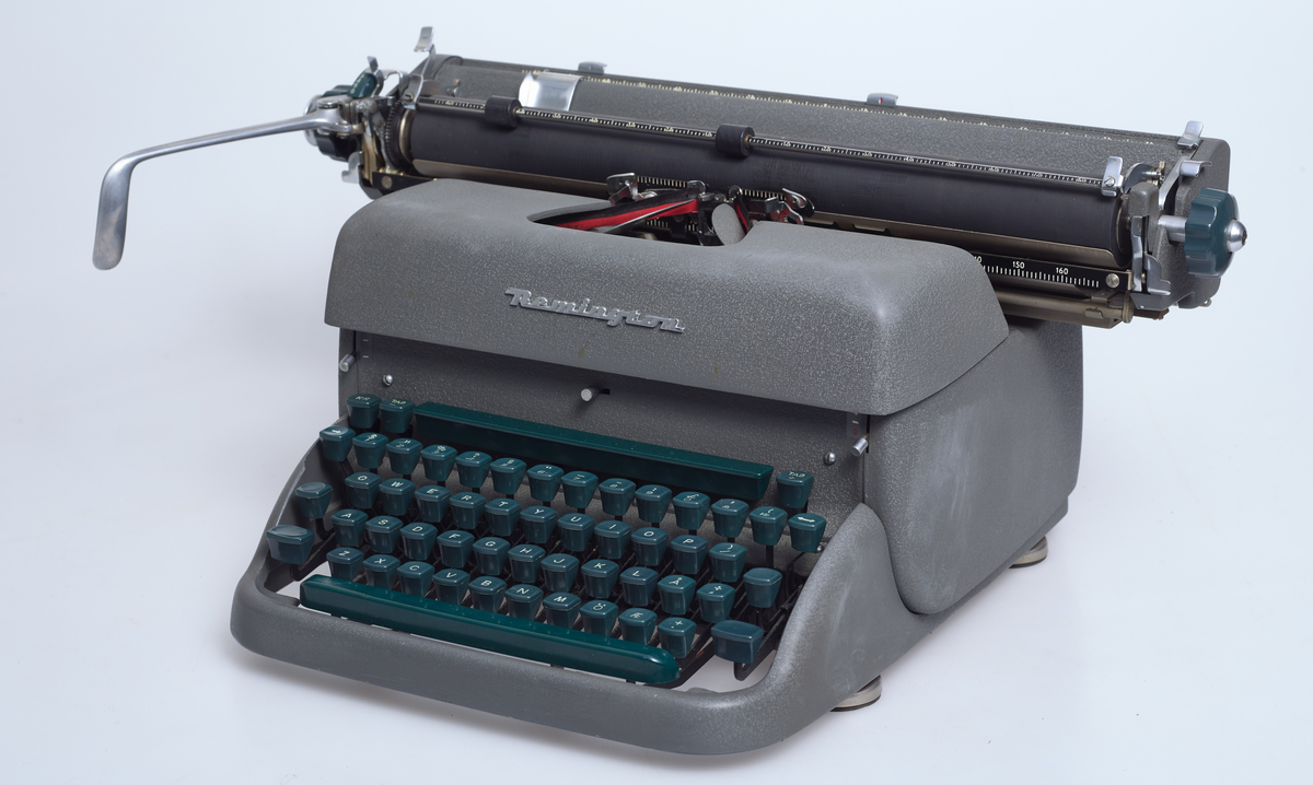 Grågrønn skrivemaskin av type Remington Rand. Grønt tastatur. Produsert (montert sammen) på Kapp Melkefabrikk i 1950 åra.