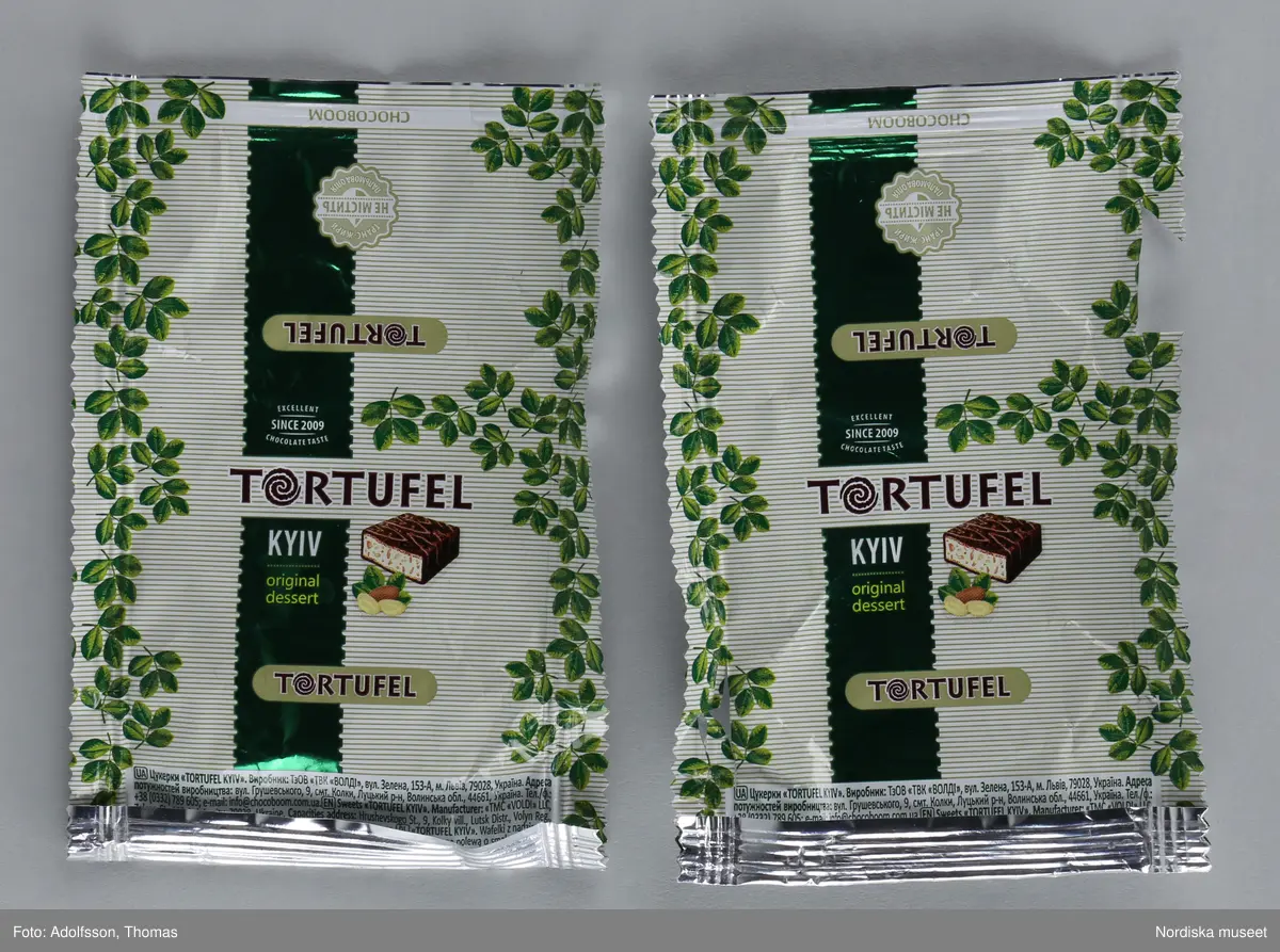 Kolorerad plåtask med lock avsedd för chokladpraliner. Asken är dekorerad med flera olika bildmotiv i blått, brunt, svart, gult och orange. Inuti asken finns 26 omslagspapper till chokladpralinerna i olika färger och mönster.
Motivet på askens lock heter "Russian warship, go...! Glory to Ukraine!". I mitten syns en ukrainsk soldat som skulle kunna vara gränsvakt. Ute på havet framför soldaten syns ett ryskt krigsskepp som kan identifieras som misilkryssaren Moskva byggd 1982. Den ukrainska soldaten är vänd mot skeppet. I sin vänstra hand håller han ett maskingevär och med den högra handen gör han en obscen gest mot fartyget.