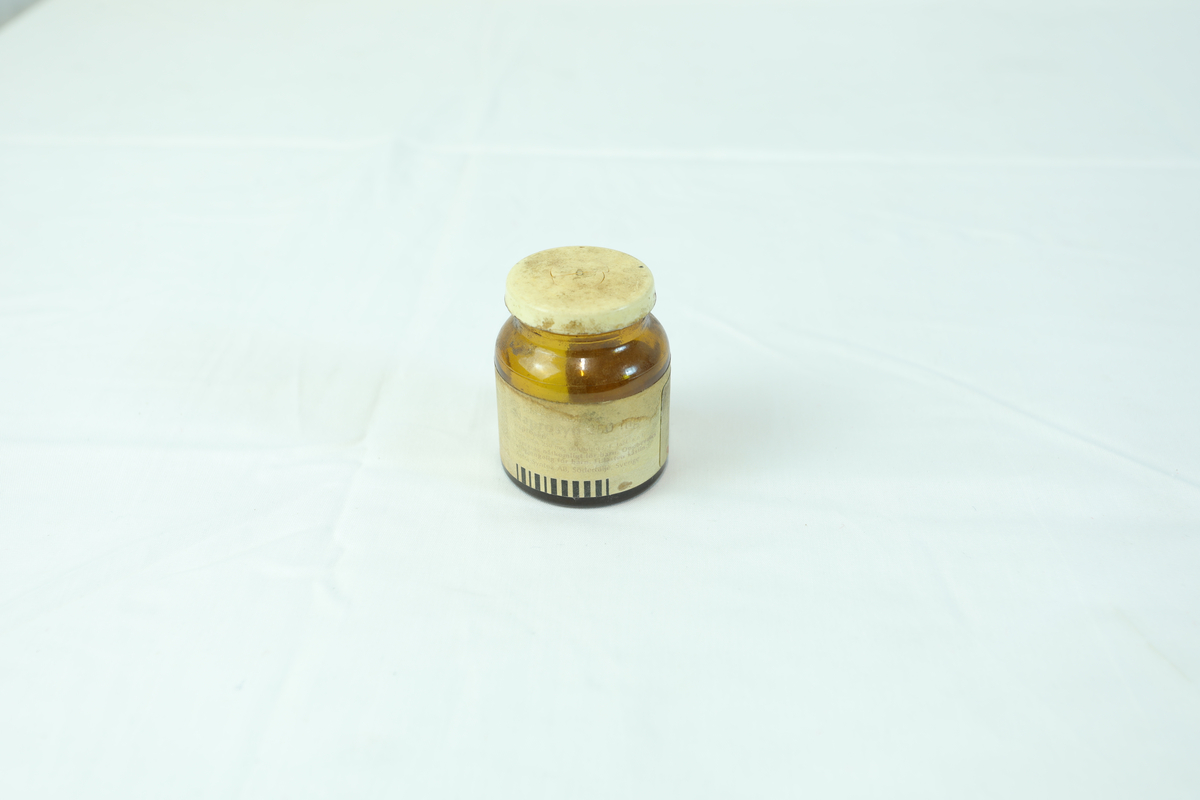 Glasskrukke brukt til oppbevaring av medisin.