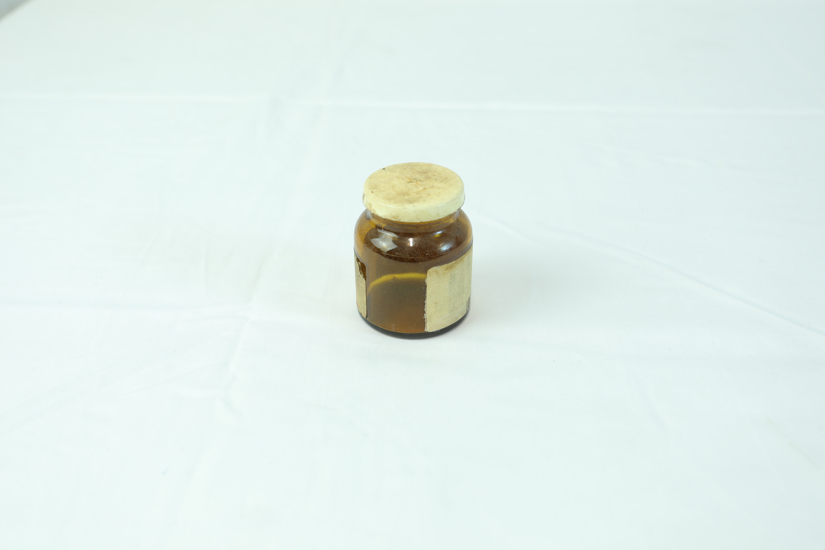 Glasskrukke brukt til oppbevaring av medisin.