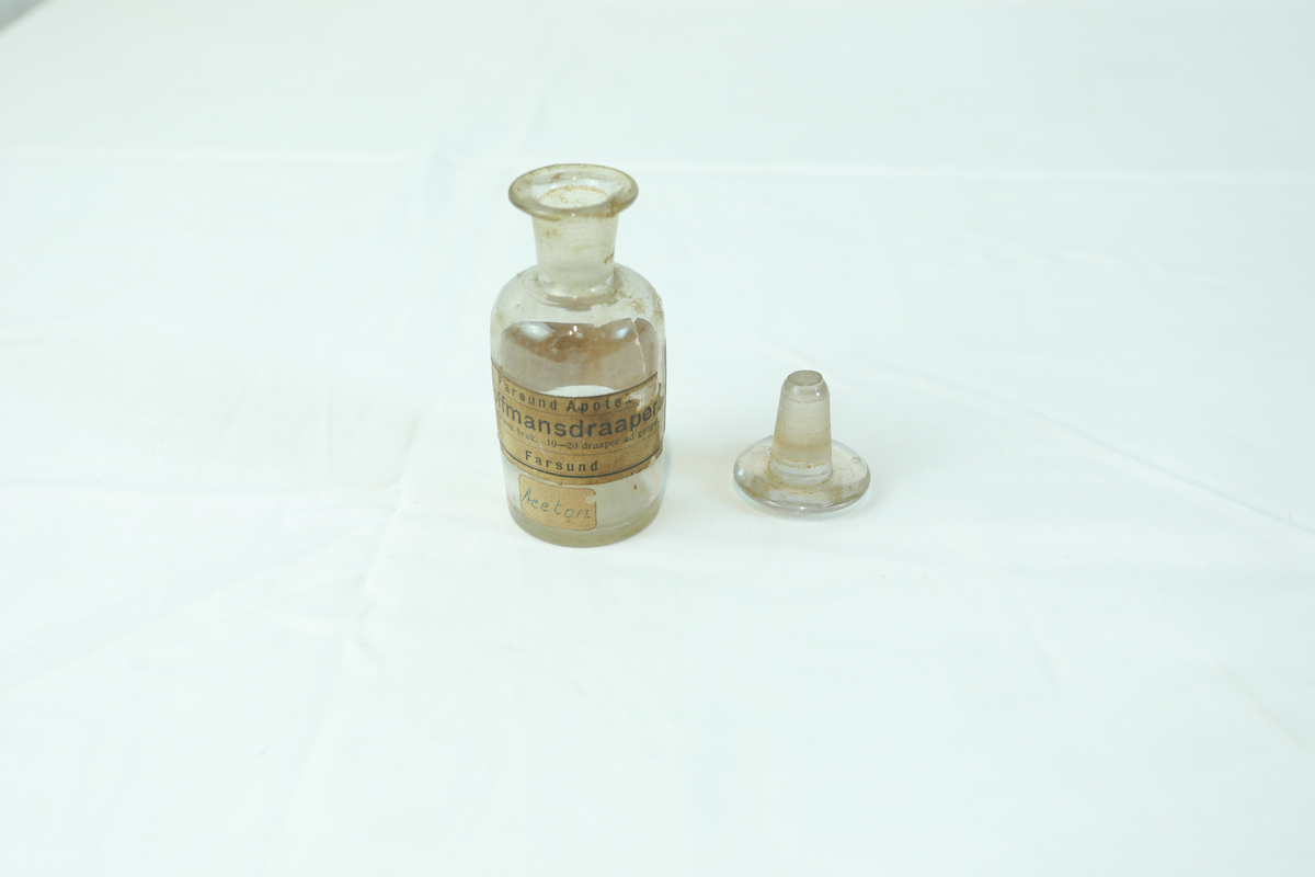 Medisinflaske med glasslokk. Har vært brukt til oppbevaring av medisin.