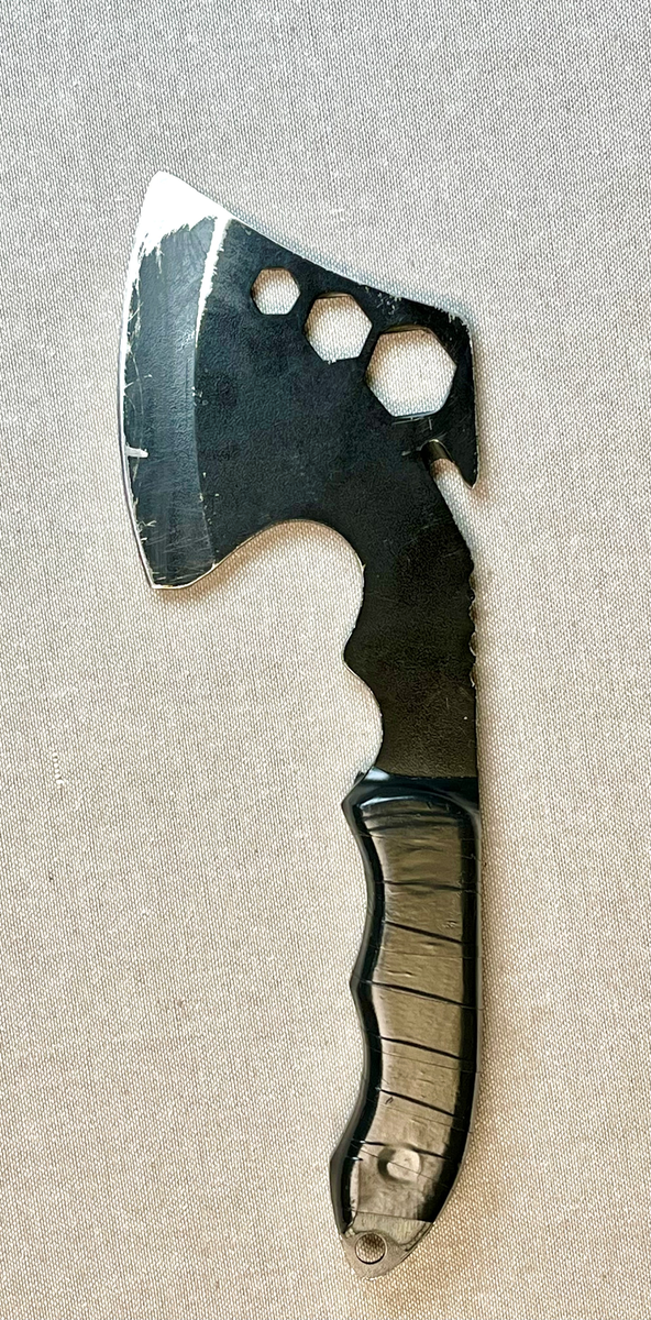 Liten kasteøks mes slire i nylonstoff. Sliren er delvis revnet. Skaftet er forsterket med sort tape.