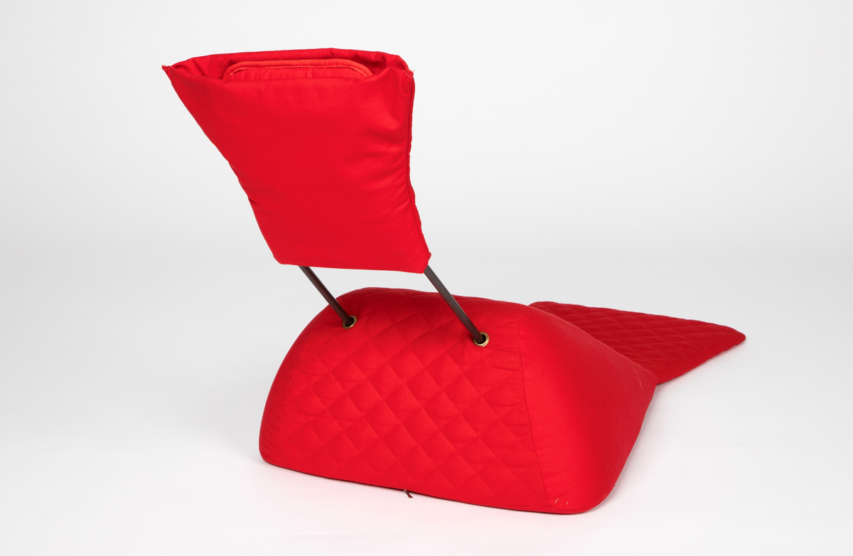 Liggestol konstruert ergonomisk spesielt for ligging på magen. Liggedel og pannepute er laget av fast skumgummi og trukket med kraftig quiltet bomullsstoff. Liggedelen er skrå pyramideformet, som en hoppbakke, og flater ut ytterst. Panneputen er festet til stålrør som står opp fra øverst på liggedelen. Putens nederste del kan brettes opp slik at det blir en åpning til ansiktet. Stolen er lett, og er tenkt å kunne tas med opp i senga for en behagelig lesestilling. Glidelås på underisden av liggedelen.