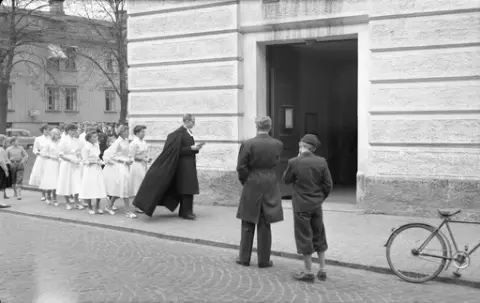 Konfirmationspräst Hans-Åke Ljungqvist med sina konfirmander i stadskyrkan 1954.