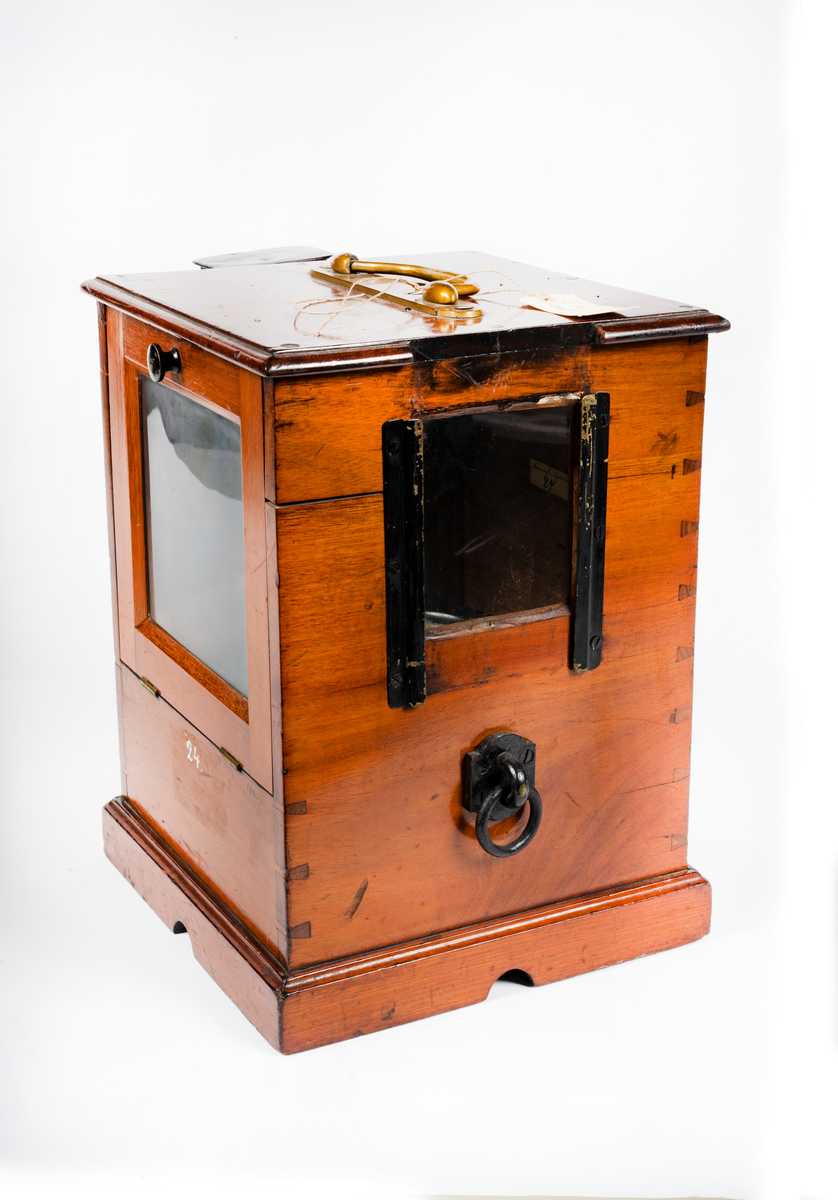 Båtkompass med nakterhus av mahogny. Kompass, sprit, märkt: "G.W. Lyth, Stockholm 7381", samt med vit färg "N. 24" (förrådsnummer). 
Ros streckindelad, märkt: "Patent Lemcke. G.W. Lyth. Stockholm". Nakterhus, fyrkantigt, med dörr. Fäste för 2 lanternor.
Märkt med vit färg "24".