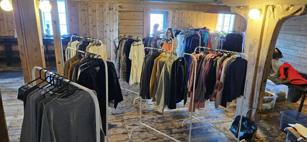 Her ser vi flere stativ med klær som er til salgs på bruktmarkedet