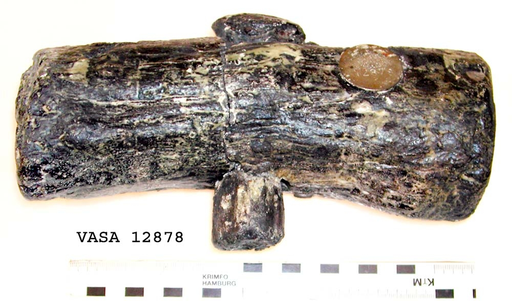 Huvud till klubba. Tämligen gott skick, sånär som att en fjärdedel av huvudet slagits loss. En del av skaftet sitter kvar i hålet.

För mer information se Dokumentationsblankett under Referenser – Länkade filer.