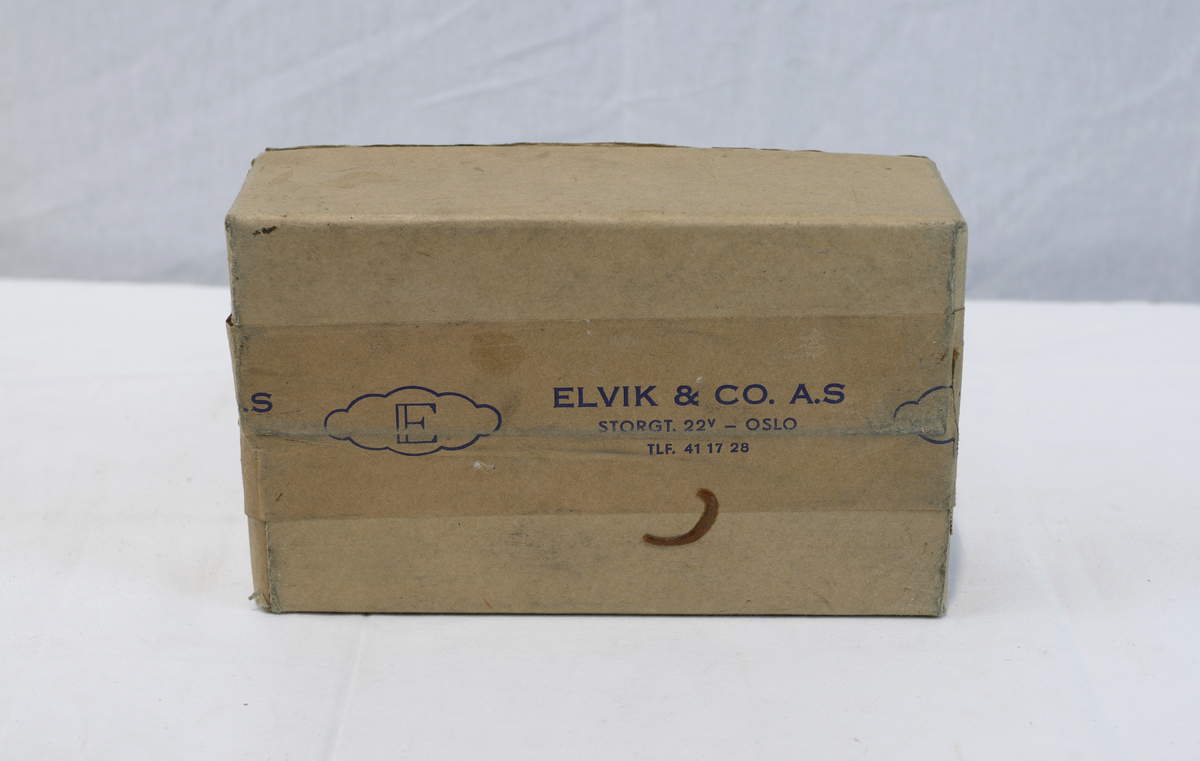 Del av pappeske. Esken har brun papirtape med logo. Brukt til enten oppbevaring eller innpakning av gullsmedgjenstander.