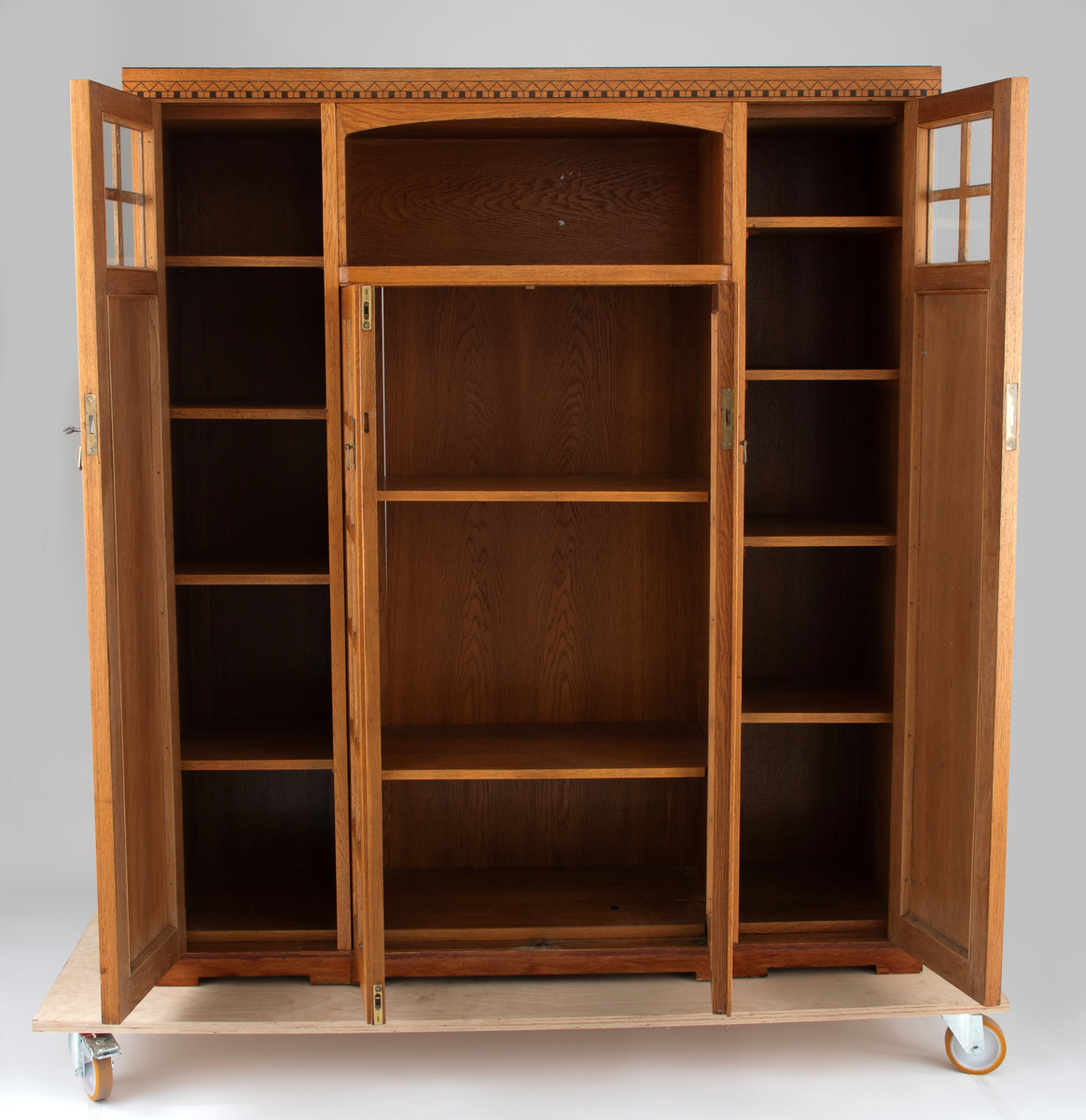 Buffet i bonet eik, dekorert med intarsia av ibenholt (?) og messingbeslag. Møblementet har en streng arkitektonisk oppbyggning, og preges av et spill mellom vertikale og horisontale volumer. Midtpartiet består av et vitrineskap med dobbeltdører, dekorert med felt av krysspostvinduer. Det rektangulære overskapet har svakt buet innramming. På hver side av midtpartiet to smale vertikale skap, hvis dører er dekorert med intarsia i form av geometriske jugendornamenter. Buffeten avsluttes med et profilert toppstykke.