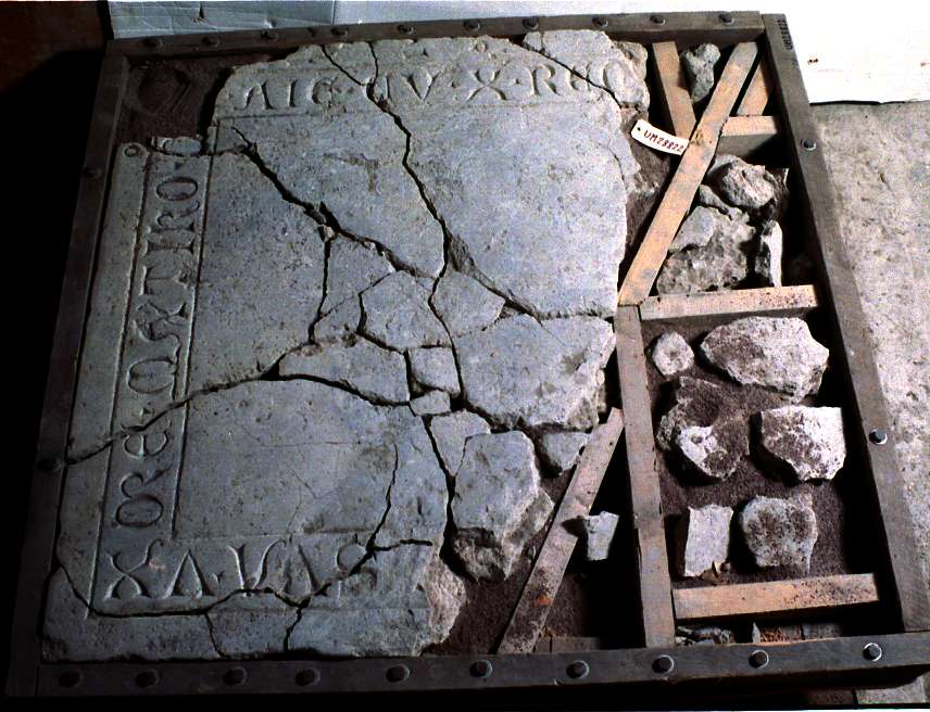 Gravhäll, i flera delar, av kalksten. 
Gravhällen är sannolikt från 1300-talet. Större delen av inskriften saknas. Del av inskriften: --- SVA . VX / ORE . MATIKO (?) SAMT ANIME . CVM . X (=CHRISTO) . REQVESCAT ---.  I översättning: "--- hans hustru---" samt "--- deras själar vila i frid---". Namnen på mannen och hustrun som begravdes saknas, även årtal saknas. Texten MATIKO kan eventuellt vara hustruns namn.