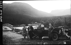 3 damer og en mann på biltur i åpen bil.