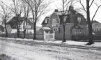 Några större villlor med trädgårdar, längs en snöig gata. Bymarken, Jönköping (?).