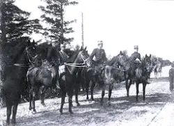 Foto av en grupp militärer till häst som är ute på fältövnin