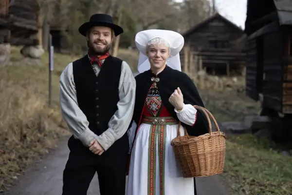 En mann og en kvinne i Hardangerbunader. 