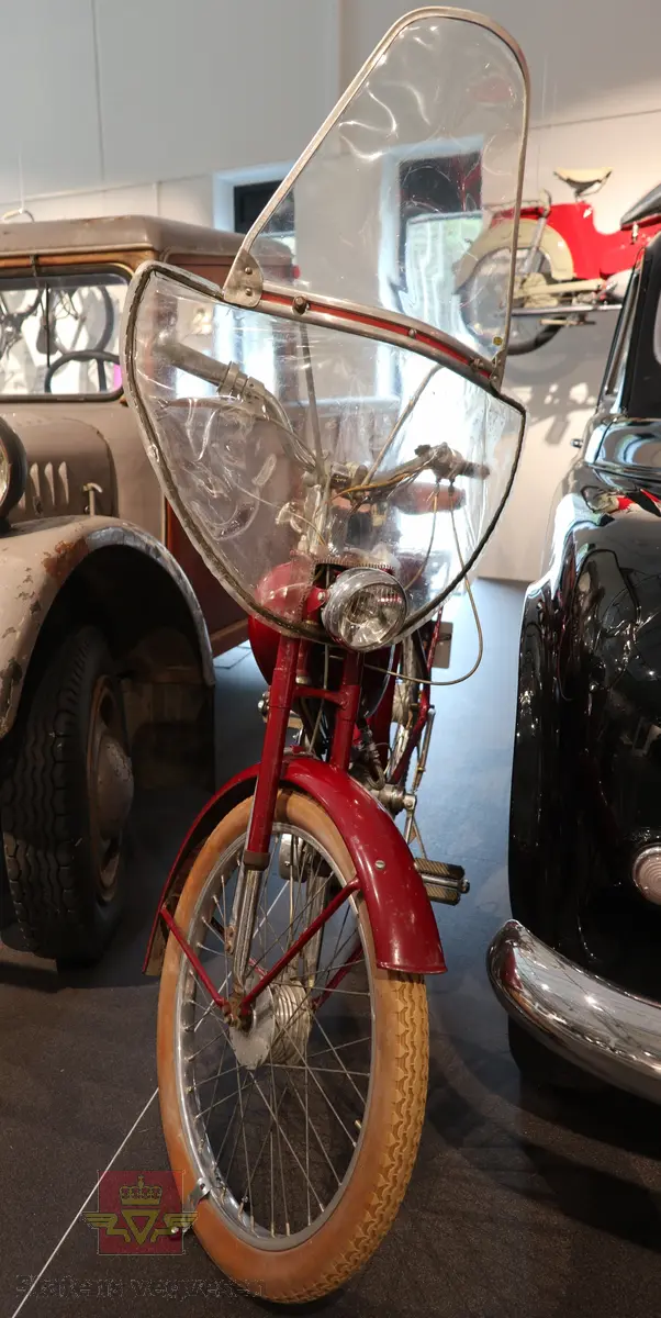 Flani Stafett type BFC-50. Mopeden er rød med svarte detaljer og flerfarget logo på begge sider av tanken. Merkeplate fra fabrikken sitter festet på gaffelen. Mopeden er utstyrt med en ensylindret BFC totakt forbrenningsmotor på 49 ccm. Motoren yter trolig 2,5 hk og går på bensin blandet med totaktsolje i forholdet 1:20 (5% olje). I tillegg til motoren har mopeden pedaler slik at man tråkke for bedre effekt i motbakkene. Mopeden har håndgir (to gir), lys og midtstøtte. Mopeden er urestaurert. og tilnærmet original. Reflekser og baklykt er ikke originale. Bakdekket er også byttet, opprinnelig var det hvitt. Framdekket er trolig det opprinnelige hvite, som har blitt misfarget. Mopeden har vindskjerm påmontert, det ser ut som nedre del av vindskjermen er hjemmelaget. Dekk er av dimensjonen 2,25 x 24.