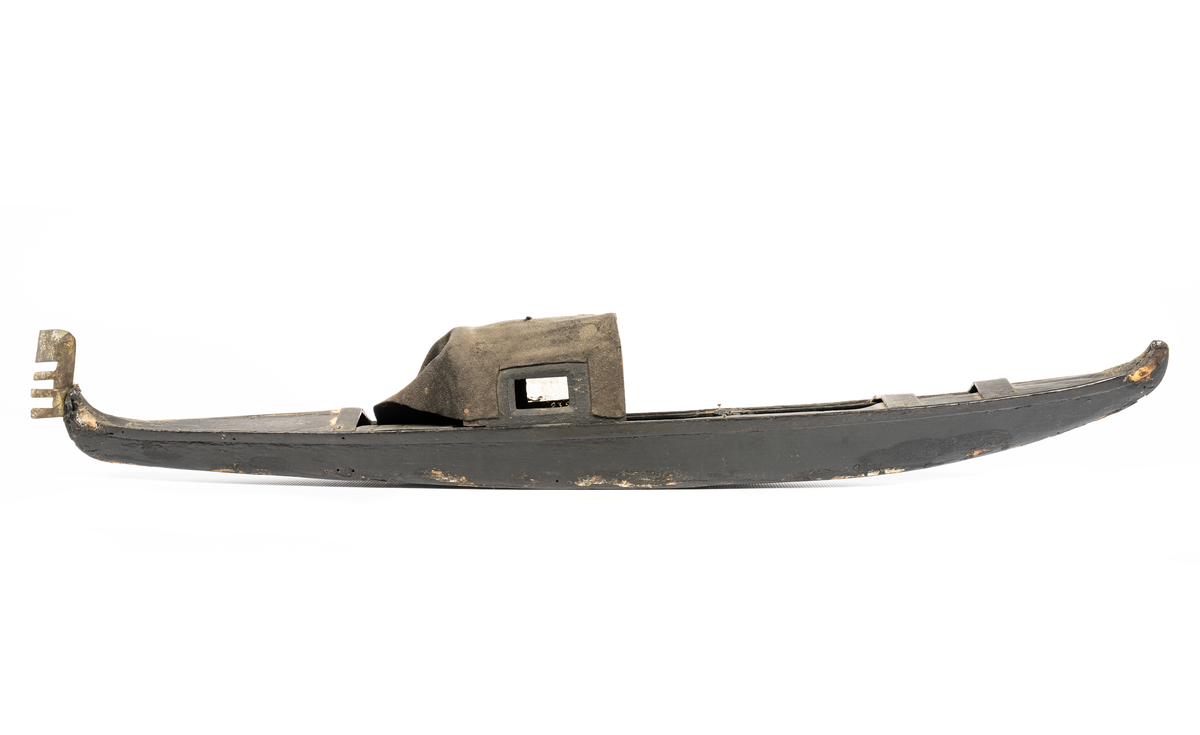 En bred bottenplanka. Bordläggning: Ett bord på var sida. Överbyggnad: Duk spänd på träram. En stävprydnad.Föremålets form: Spetsgattad