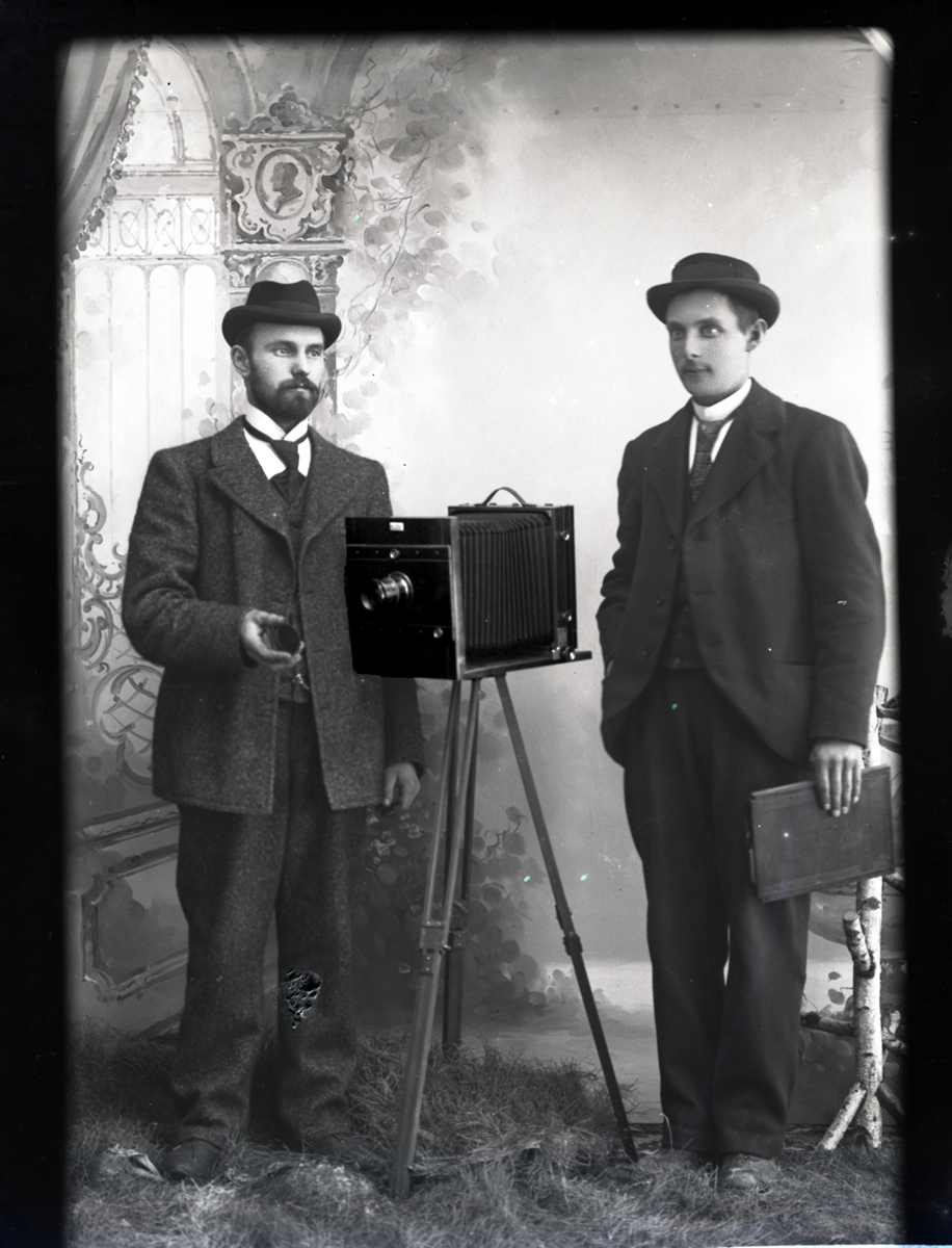 To menn med et kamera.
Skrevet på papir som er festet til negativet: 389  Herr Alme ( kanskje de er i slekt med fotograf Marthe Alme?), se bilde GM_MG.03456_2.