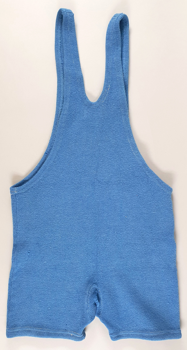 Blå brytedrakt av ull med norsk flagg på brystet.