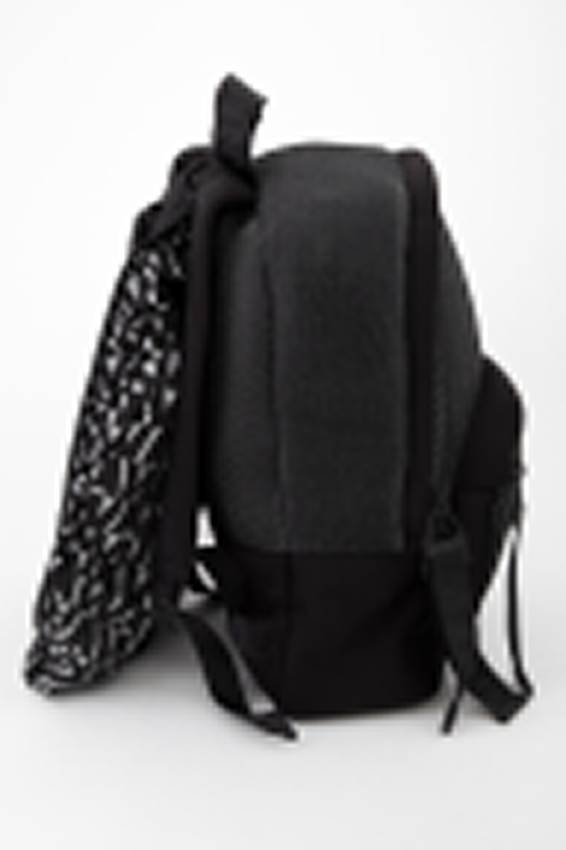 Liten sekk for trening. Sydd av nettstoff, der det ytre stoffet er laminert med flere lag nettstoff, og kjernen antagelig selvlysende, dvs av lysegrå refleksfibre. Sekken består av ett hovedrom og et lite ytterrom. Nedre del av både sekk og ytterrom er av tett neopren. Selve bunnen har en påsydd plate av gummi, med 4 "ben" i form av logoen "AW".  Innvendig bunnplate er imidlertid både bredere og lengre og av ukjente materiale. Sekken er flat nederst og buet i overkant, hovedrommet åpnes nesten helt ned i begge sider og lukkes med grov plastglidelås. Ytterommet åpnes i overkant og lukkes med tilsvarende glidelås. Innvendig er rommene fôret med et ekstra lag, enkelt nettstoff, og hovedrommet utstyrt med en ekstra lomme. Selene er regulerbare med spenner, er polstret, av neopren og utvendig forsterket med påsydde bånd av bevernylonlignende materiale ivevd "WANG" gjentatte ganger. Tilsvarende stropp øverst, til bæring i hånden. Under selefestene en ekstra lomme, lukket med samme grove glidelåstype. Nedi lommen ligger et påsydd regntrekk av tynt, vannavstøtende matriale, med påtrykt "AW" i et sammenhengende mønster utført i lysreflekterende trykkfarge over det hele. Med påsydd elastikk langs ytterkanten, kan trekket raskt tas ut og vikles omkring sekkens front og holde seg på plass i regnvær. Alle glidelåser er utstyrt med en "drastropp" av det sorte båndet ivevd WANG.