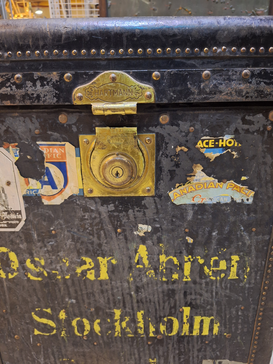 Inredd koffert som tillhört postorderkungen Oscar Ahrén (1881-1948). Kofferten är inredd med galghängare och lådor. På utsidan klistermärken från olika delar av världen.