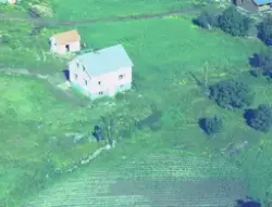 Flyfoto over sannsynligvis over gård i Sørreisa i 1961.