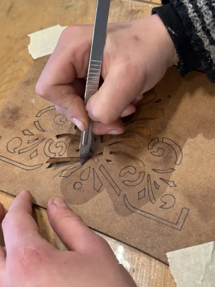 nærbilde av noen som skjærer ut sjablongmønster