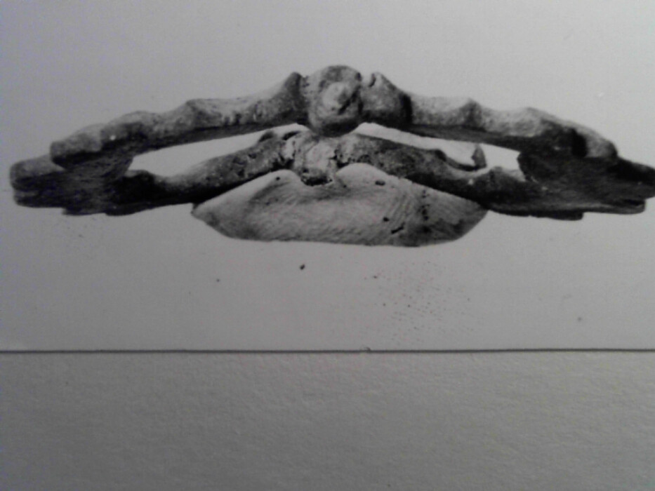 messing. stol og torn mangler. tilnærmet rektangulær. ornert på oversiden med brust C-er og hjerteformer.