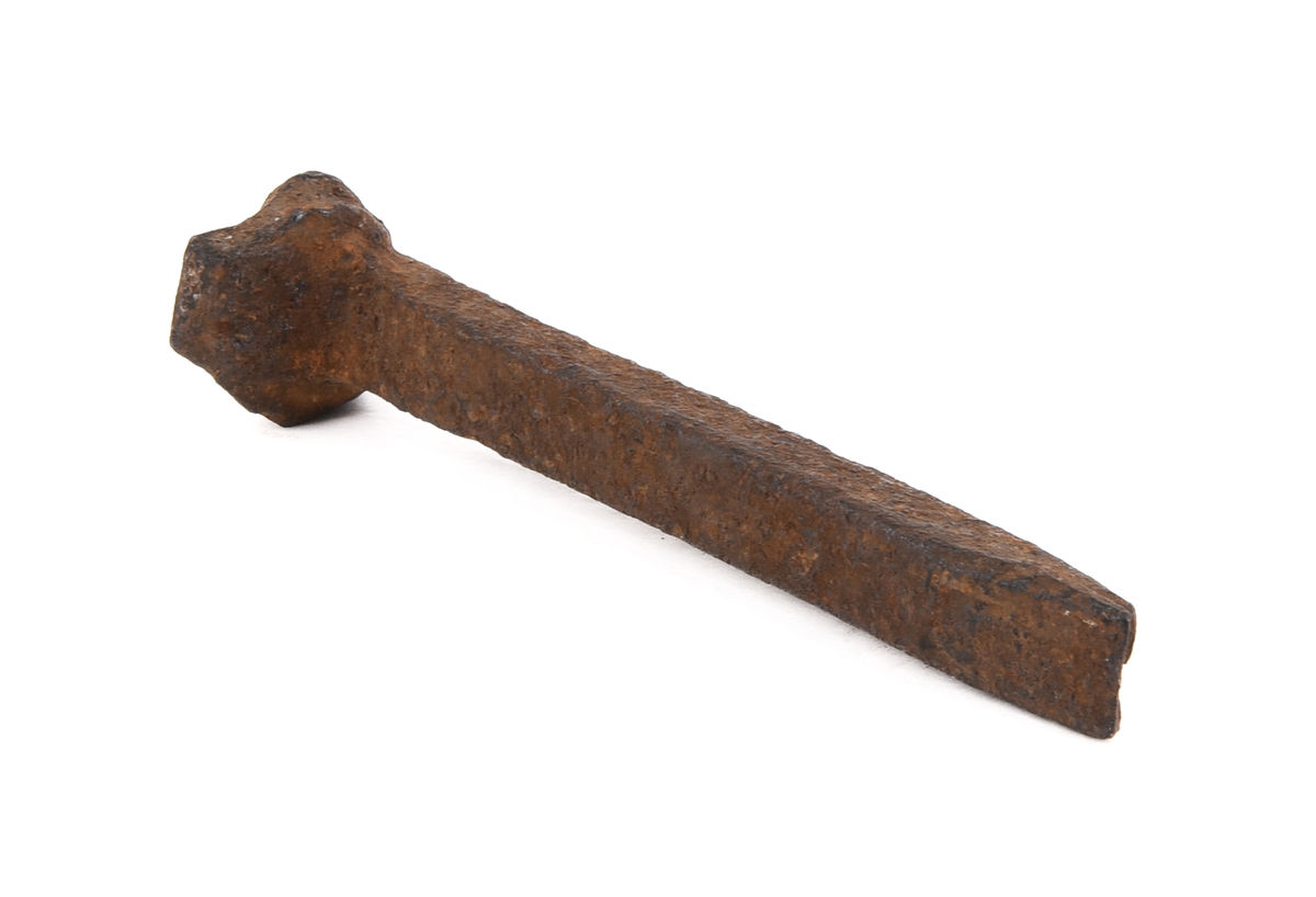 Rälsskarv (:2) av järn med underläggsplatta (:3) samt rälsspik (:4).