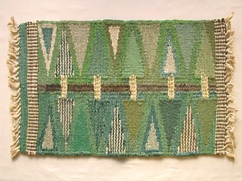 Mattprovet är vävt i rölakansteknik.
Mattans mönster består av heltäckande mönster. Mattan liknar "Pilevall", p.g.a. alla
pilar som täcker  ytan. Bottenfärgen är grön,mönstret går i grönt,gult och grått.

Skiss finns.

Mattprovet är vävt på Önnestads mattväveri.

Varianter av denna färgställning, se inv.nr 1216-17. Finns äv. i grått, inv.nr 1218.