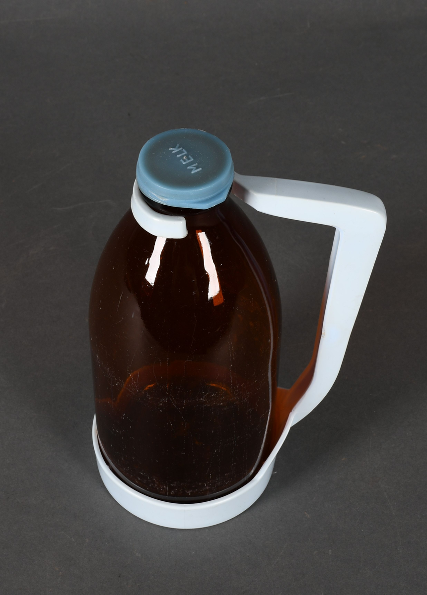 Flaske i brunt glass, med lyseblå plastholder og mellomblå plastkork.