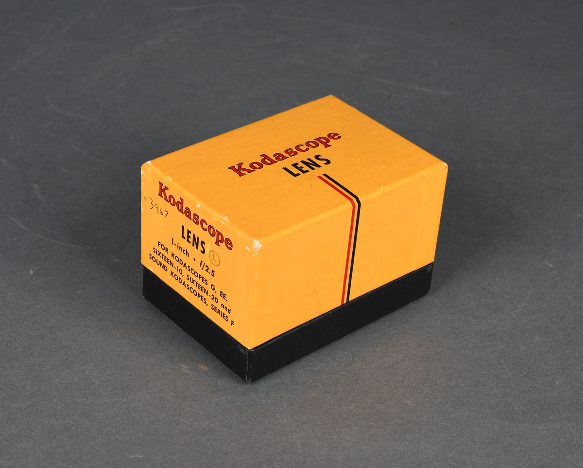 Linse til filmkamera i pappeske med hengslet lokk.