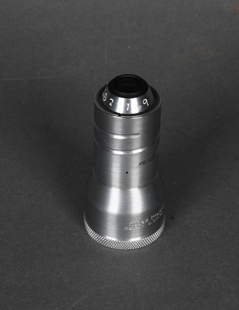 Linse til filmkamera i pappeske med hengslet lokk.