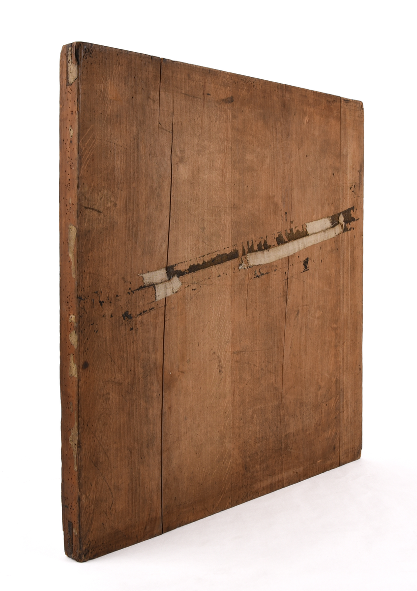 Ett mätbord på stativ med fodral.

Jvm01938-1: Mätbord bestående av en kvadratisk träskiva. Har använts för att spänna upp papper för att kunna göra ritningar. Framtill sitter två tejpbitar i vitt. Baktill finns fraktsedlar där det står bland annat i svart text "Hagalund, Ilgods fr. Värtan, Stockholm Central(?), 1863" på olika ställen. Finns även fyra svarta och röda sigillstämpelar där texten är svår att tyda. På baksidan sitter även stativhuvudet. Gjord av metall och trä och består av flertal skruvar. 

Jvm01938-2: Ett fodral gjord av vävd bomull med påmålad svart färg för att skydda mätbordet mot vatten. Sömmen i mitten av fodralet är sprucken och det har uppkommit hål där träskivan har skavt mot fodralet. Banden på fodralet har lossnat på vissa ställen men knutits ihop för att sitta fast på mätbordet.

Jvm01938-3: Stativ bestående av tre ben som fästs i stativhuvudet på mätbordet. Upptill ett hål på vardera ben. Nedtill spetsiga ben, klädda i metall. Kvadratiskt formad med rundade hörn.