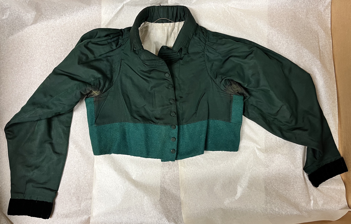 Sognebunad med følgande deler:
Belte - sölvkjede - silketörkle - tröye - silkeforkle - konehue - stakk - brosje - spenne/sölje - veske med lås.