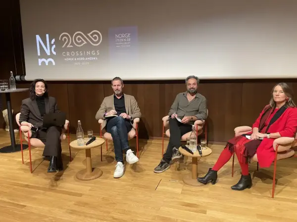 En paneldebatt med to menn og to kvinner som sitter i hver sin stol.