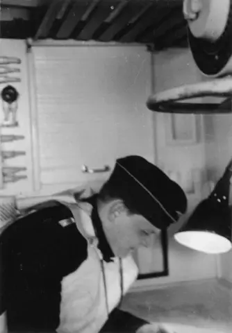 Fartøysjef Seidel leser sjøkart ombord på motorminesveiperen "R 156" ved 7. motorminesveiperflotilje (7. R-Fl) i 1943. Fototekst:: "Kommandant Seidel im Kartenhaus".